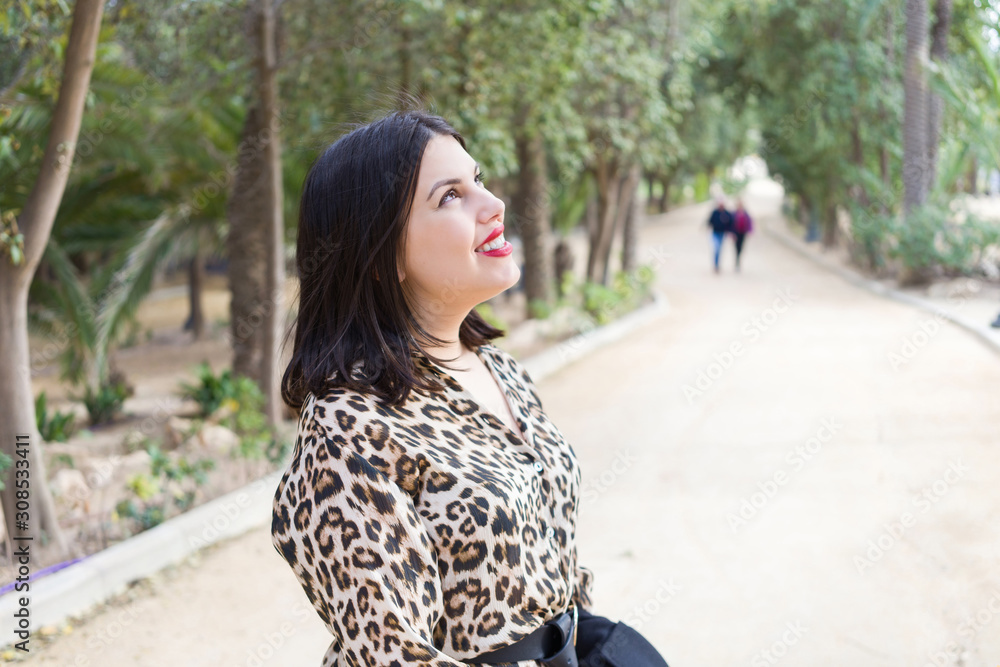 Young beautiful woman with red lips smiling happy at garden Young beautiful woman with red lips smiling happy at garden