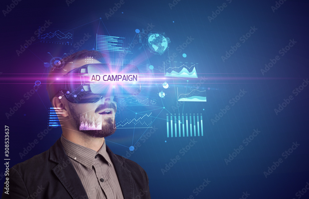 Businessman looking through Virtual Reality glasses with AD CAMPAIGN inscription, new business concept Businessman looking through Virtual Reality glasses with AD CAMPAIGN inscription, new business concept
