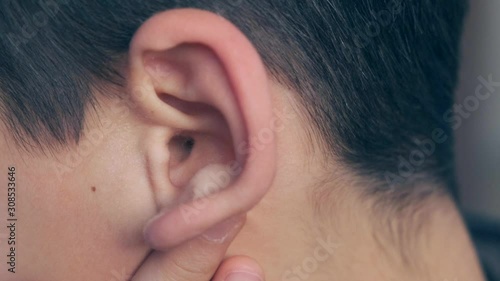 a child is scratching his ear, ear pain and inflammation in infants,
