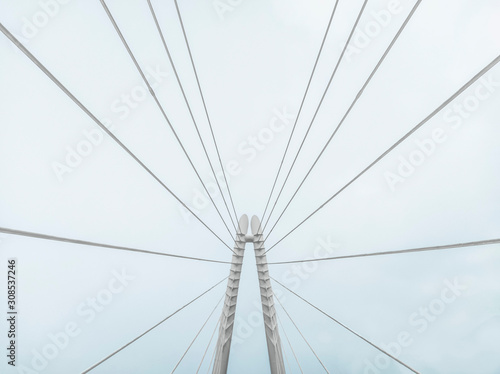 composition of a white cable stayed bridge with a foggy background