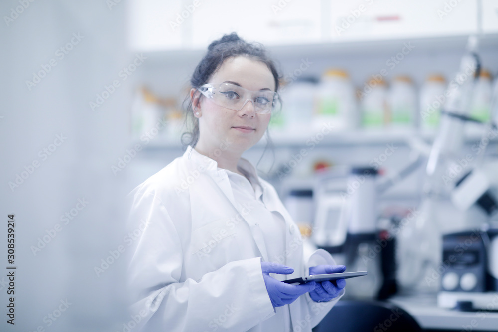 young scientist female with tablet in a laboratory young scientist female with tablet in a laboratory