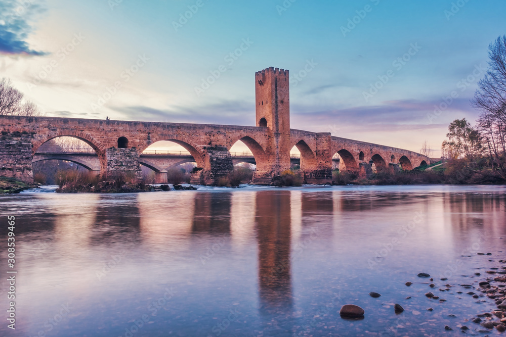 Medieval fortified bridge over the river in Castilla y Leon, Spain.