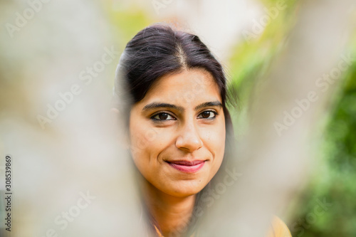 young woman outside smiling with unsharp front