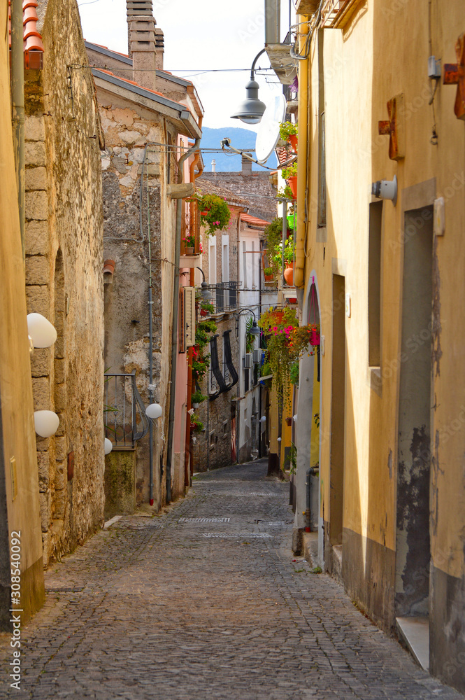 Fototapeta premium Capriati in Volturno, Italy, 09/23/2017. A narrow street among the old houses of a medieval town