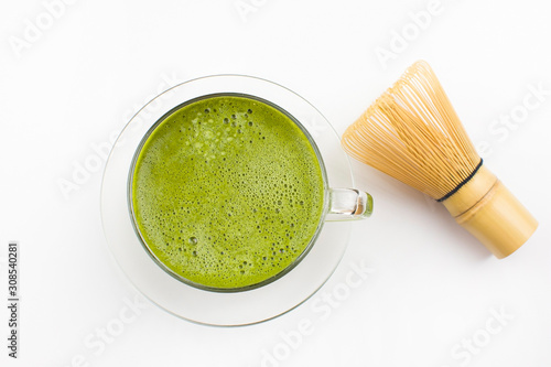 matcha tea in a cup on a white background and a whisk, selective focus