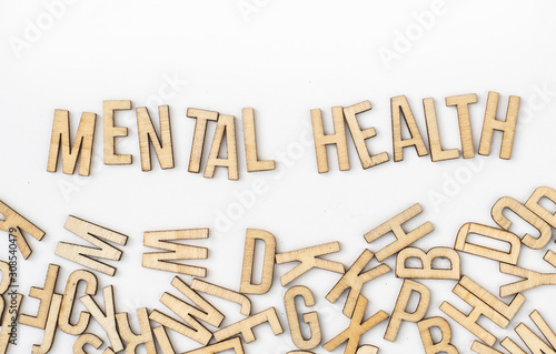 Mental health concept, word spelled out by wooden letters on white background