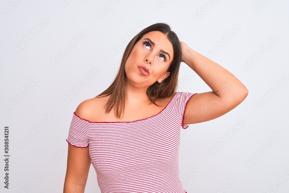 Fototapeta premium portrait of young woman looking thoughtful, thinking about a question looking up and touching head