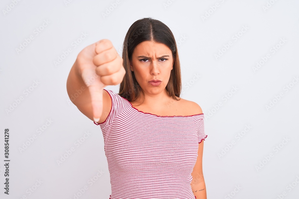Portrait of beautiful young woman standing over isolated white background looking unhappy and angry showing rejection and negative with thumbs down gesture. Bad expression. Portrait of beautiful young woman standing over isolated white background looking unhappy and angry showing rejection and negative with thumbs down gesture. Bad expression.