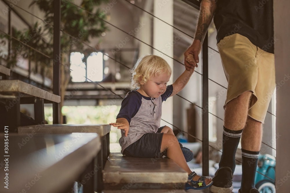 Father with little boy walking on stairs at home Father with little boy walking on stairs at home