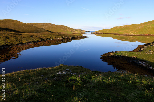 Mavis Grind, early morning reflections, narrow isthmus between North Sea and Atlantic Ocean, Shetland Isles, Scotland photo