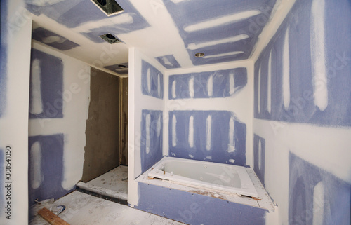 Construction remodeling a bathroom installation on interior drywall finish photo