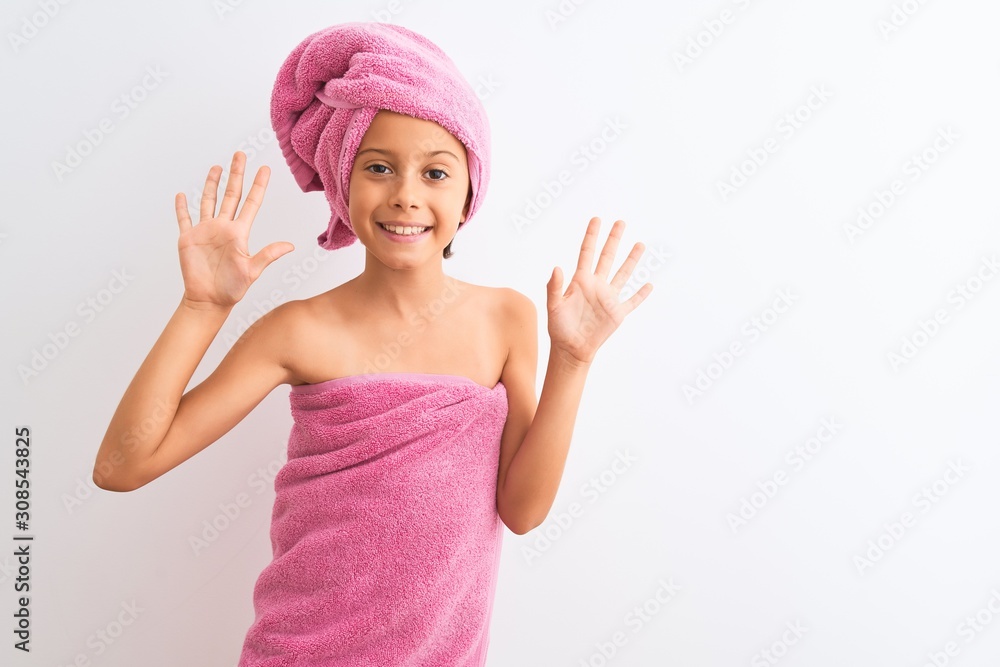 Beautiful child girl wearing shower towel after bath standing over isolated white background showing and pointing up with fingers number ten while smiling confident and happy. Beautiful child girl wearing shower towel after bath standing over isolated white background showing and pointing up with fingers number ten while smiling confident and happy.