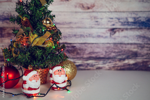 Fir tree for New Year and Christmas decorated with toys and Santa Claus.