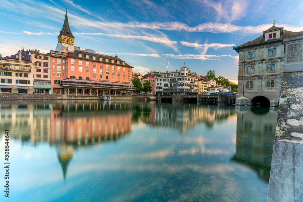 St. Peter church and old buildings of Lindenhof mirrored in Limmat River at dawn, Zurich St. Peter church and old buildings of Lindenhof mirrored in Limmat River at dawn, Zurich