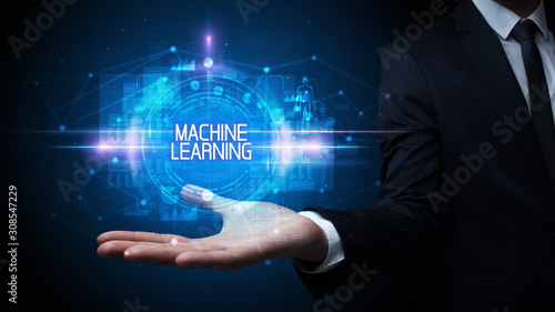 Man hand holding MACHINE LEARNING inscription, technology concept