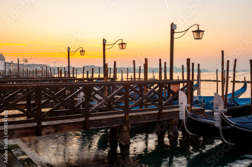 Fototapeta Naklejka Na Ścianę i Meble -  Gondolas by Saint Mark square at sunrise, Venice, Italy