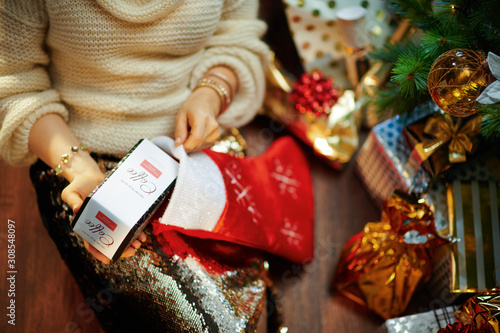 housewife getting luxury coffee present out of stocking