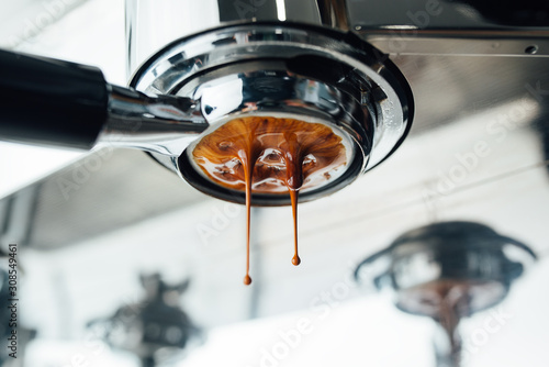 middle of the process of extracting espresso from bottomless portafilter photo