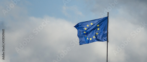 Flag of European Union waiving against cloudy sky