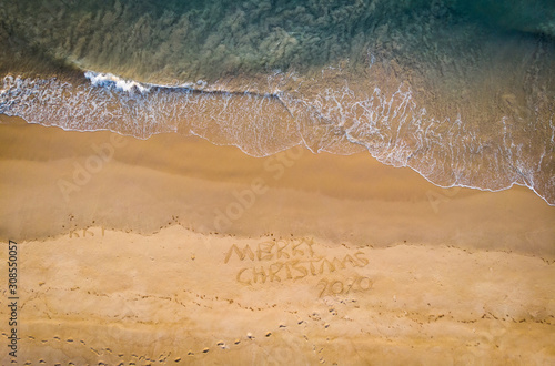 Aerial view of merry Christmas drawn in sand