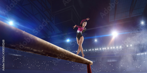 Female gymnast on professional arena.