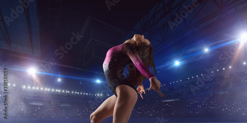 Female gymnast on professional arena.