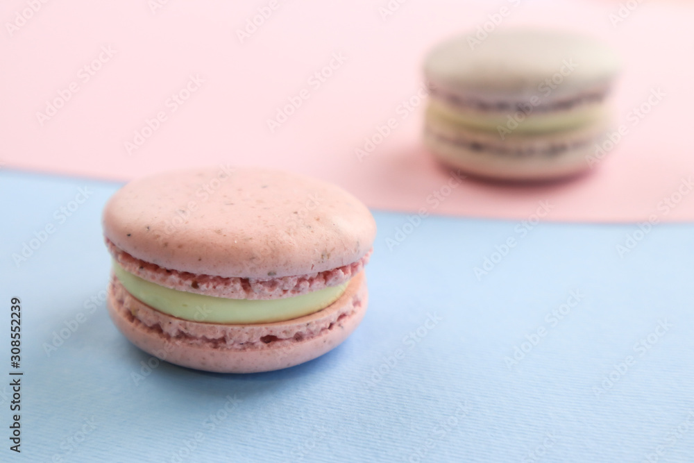 Fototapeta premium Tasty sweet macaron cakes on color background
