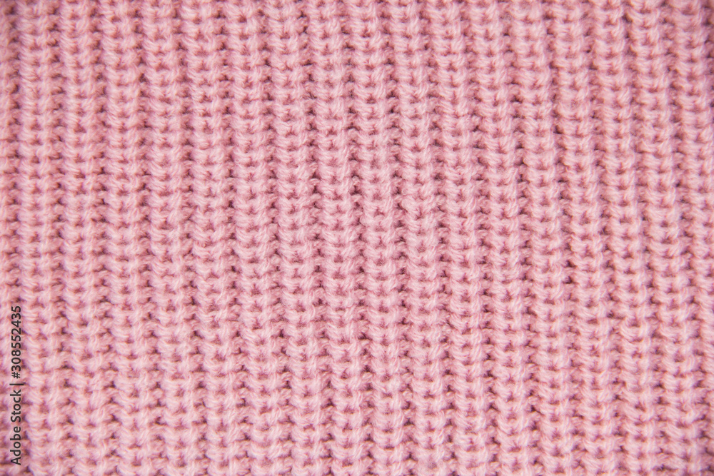 Knit close-up. Colored knitted wool close-up. Pink background. Close up of pink colored wool textile in Hi-Res Knit close-up. Colored knitted wool close-up. Pink background. Close up of pink colored wool textile in Hi-Res