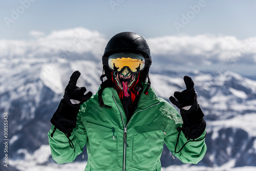 Skier in mask enjoying winter vacation.