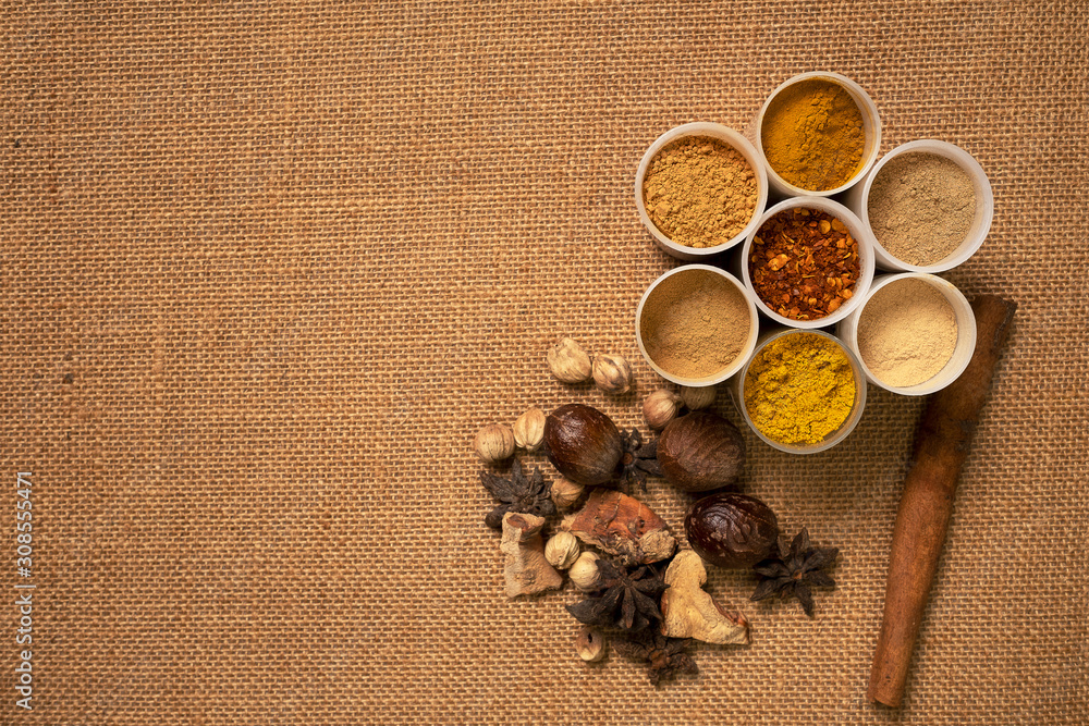 Top view mix spices and herbs different on sackcloth background with copy space for design healthy lifestyle, spices, herbs or foods and massage aromatherapy content. Top view mix spices and herbs different on sackcloth background with copy space for design healthy lifestyle, spices, herbs or foods and massage aromatherapy content.