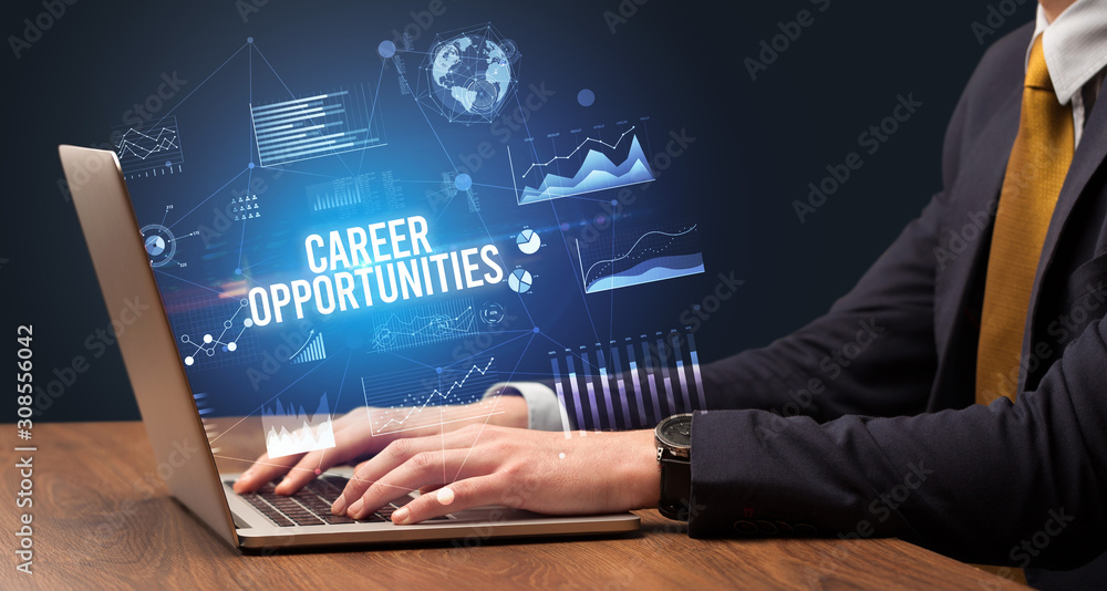 Businessman working on laptop with CAREER OPPORTUNITIES inscription, new business concept Businessman working on laptop with CAREER OPPORTUNITIES inscription, new business concept