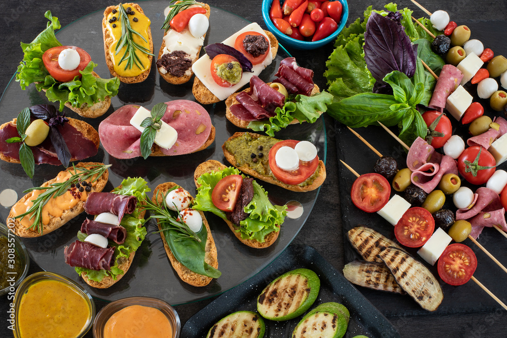 Tapas table with many kinds, Spanish pintxos Tapas table with many kinds, Spanish pintxos