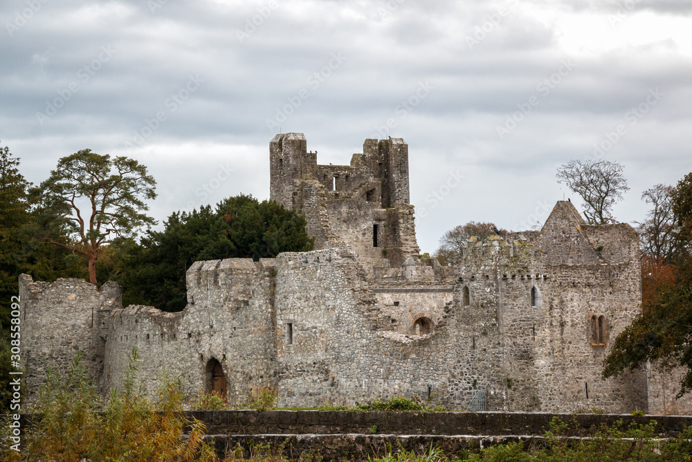 Desmond Castle on the River Maigue in Adare, County Limerick, Ireland on a cloudy day.