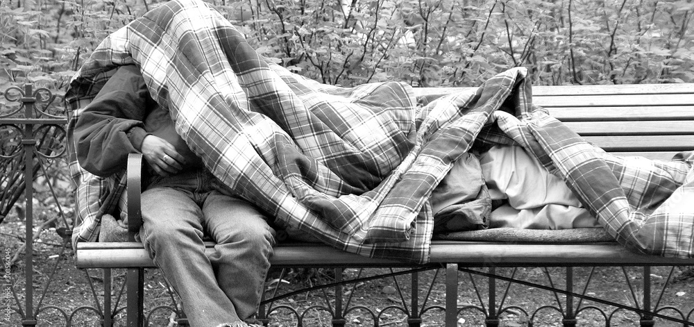 Homeless men sleeping outdoors.