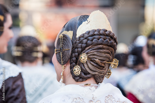 Detail from behind of typical fallera hairstyle with its jewels and the classic comb. photo