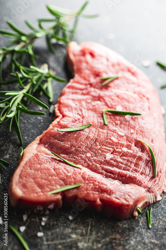 Photos Raw veal schnitzel. Raw meat and rosemary