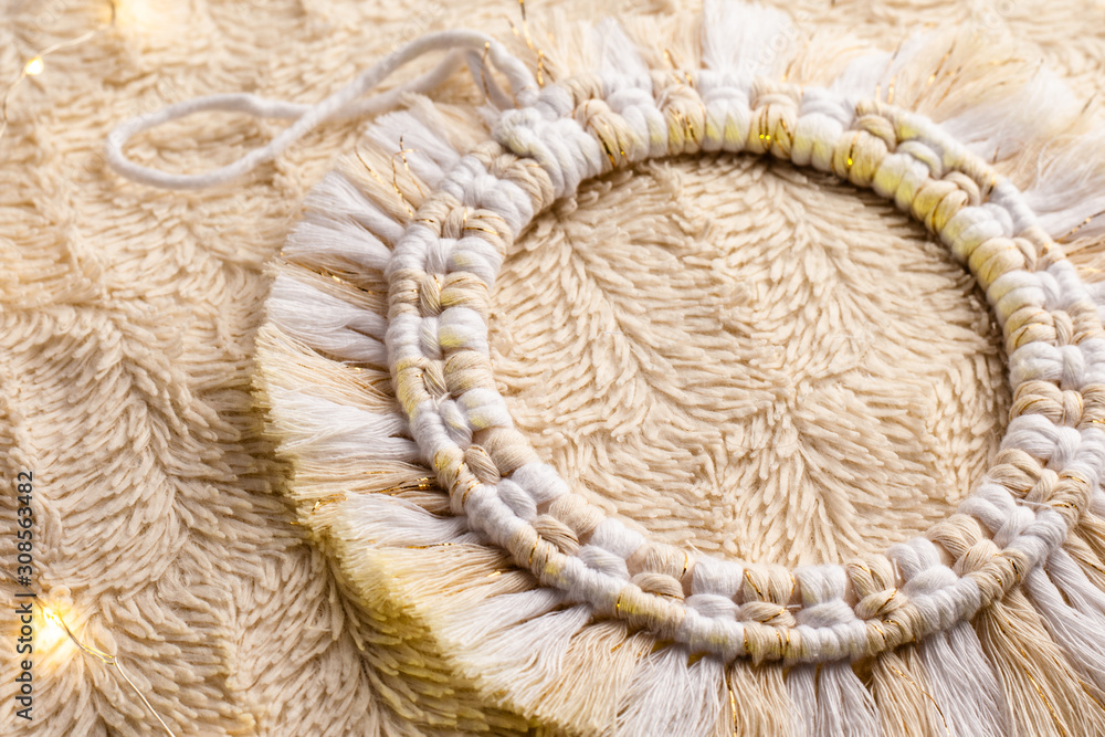Obraz premium Handmade macrame circle decoration on artificial fur