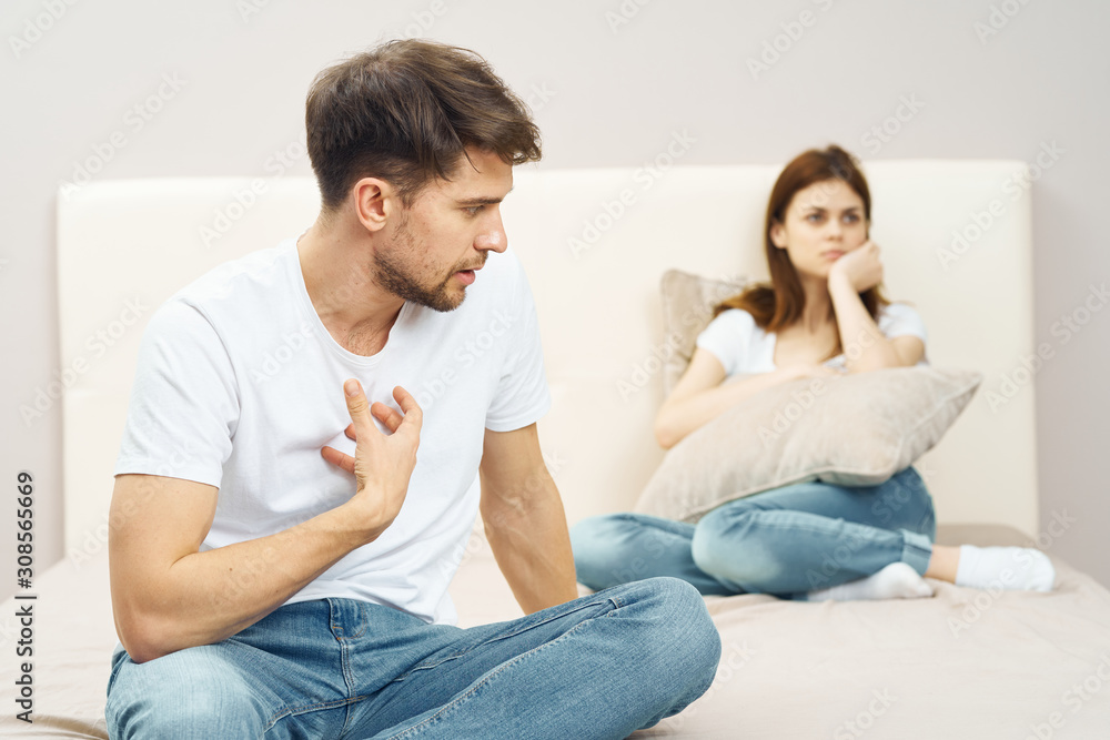 couple sitting on sofa and watching tv couple sitting on sofa and watching tv