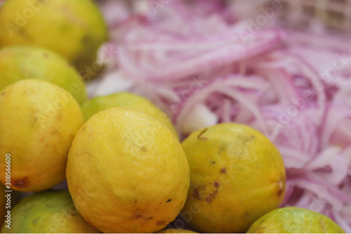 Yellow Lemon With Chopped Slices of Red Onion Blur Background