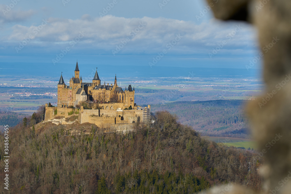 The hohenzollern castle in the foreground and a frame on the right that forms from the blur of a ruin