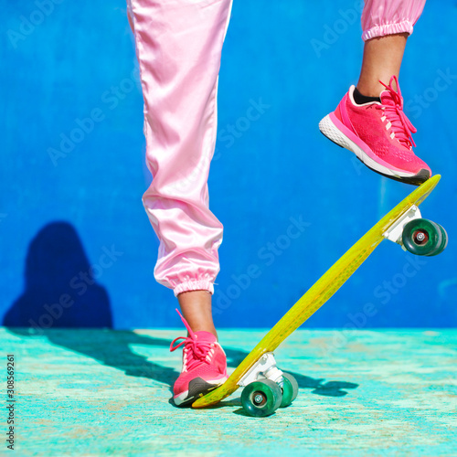 Close up view of sports legs standing on a skateboard. Riding on scateboard. Summer fun and leisure. Concept of extreme sport. © Anton Gepolov