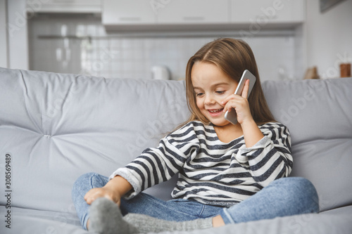 Little kid girl at home childhood concept phone call