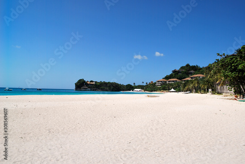 View on Balatero Cove bay fishermans village and traditional boats. Puerto Galera in Oriental Mindoro, Philippines. Banca outrigger on palm fringed beach near Isla Verde Passage and Manila. photo