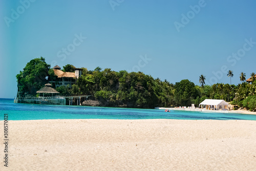 View on Balatero Cove bay fishermans village and traditional boats. Puerto Galera in Oriental Mindoro, Philippines. Banca outrigger on palm fringed beach near Isla Verde Passage and Manila. photo