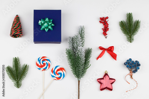 Christmas Background. Christmas Boxe with lollipops, decoration and christmas tree branches on white background