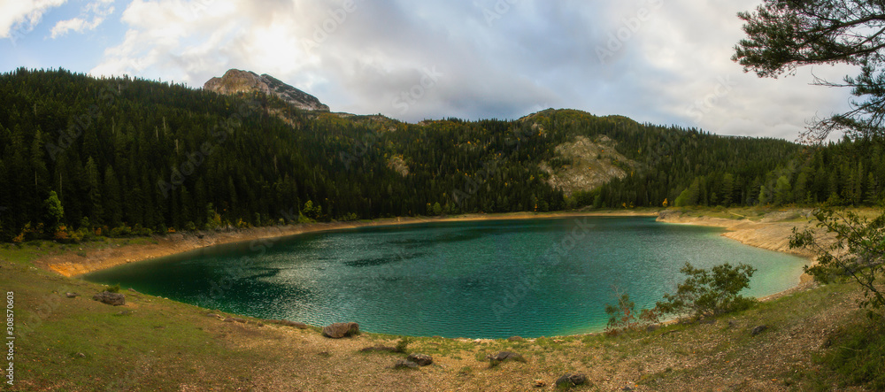 Panoramic view of the glacial Black lake (Crno jezero), forest and mountains around in the national park Durmitor in Montenegro, Europe