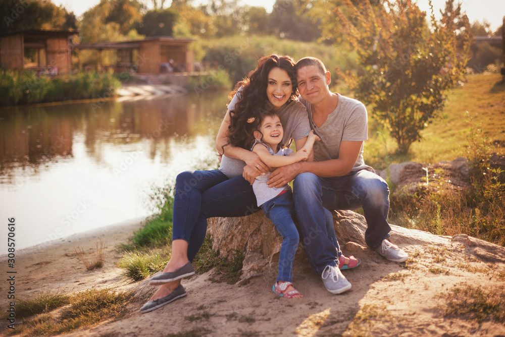 Happy pregnant family with little girl having fun in summer nature Happy pregnant family with little girl having fun in summer nature