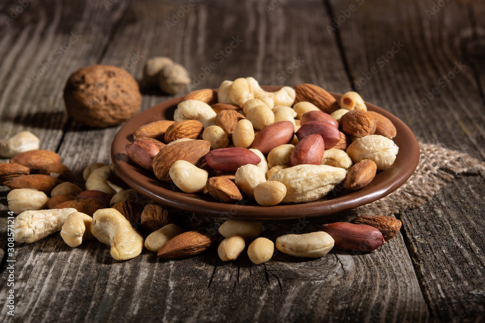 hazelnuts, cashews, peanuts on a wooden background hazelnuts, cashews, peanuts on a wooden background