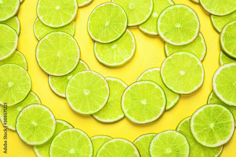 Juicy fresh lime slices on yellow background, flat lay