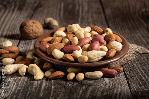 hazelnuts, cashews, peanuts on a wooden background